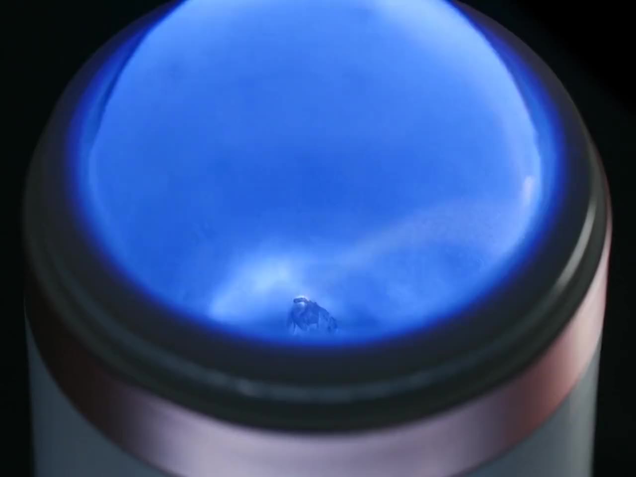 Close-up of the plasma head glowing blue, on a black background